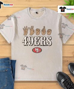Alt Text: Youth in an Official San Francisco 49ers Football T-shirt shows love with hand signals, celebrating team spirit.