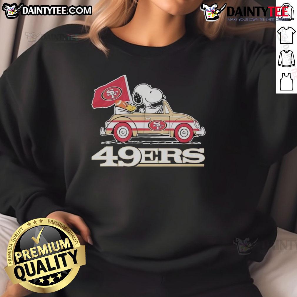 Official San Francisco 49Ers X Snoopy With Woodstock Driving A Car Sweatshirt Alt Text: Official San Francisco 49ers x Snoopy sweatshirt featuring Woodstock driving a car in team colors.