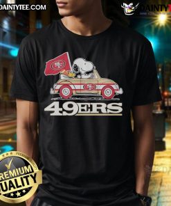 Alt Text: Official San Francisco 49ers X Snoopy T-Shirt featuring Woodstock driving a car, perfect for fans and collectors.
