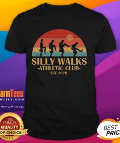 Vintage sunset t-shirt featuring 'Official Silly Walks Athletic Club Est 1970' design, perfect for fans of quirky humor.