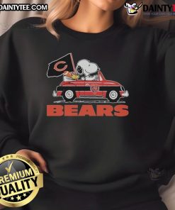 Snoopy and Woodstock driving a car on a Chicago Bears sweatshirt, perfect for fans and cozy wear.