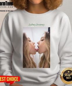 Alt Text: Sydney Sweeney kissing a mirror while wearing a stylish sweatshirt, showcasing her unique fashion sense and charm.
