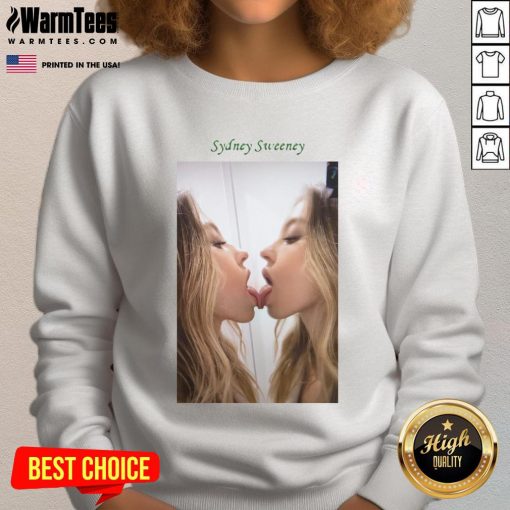 Alt Text: Sydney Sweeney kissing a mirror while wearing a stylish sweatshirt, showcasing her unique fashion sense and charm.