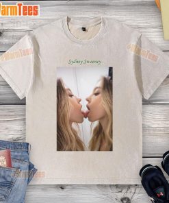 Official Sydney Sweeney kissing a mirror while wearing a washed t-shirt, showcasing her playful style and charisma.