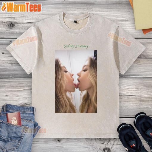 Official Sydney Sweeney kissing a mirror while wearing a washed t-shirt, showcasing her playful style and charisma.
