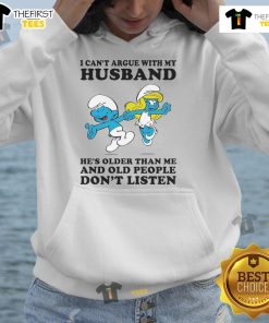 Woman wearing Official The Smurfs 'I Can't Argue With My Husband He's Older Than Me' hoodie, showcasing fun and humor.