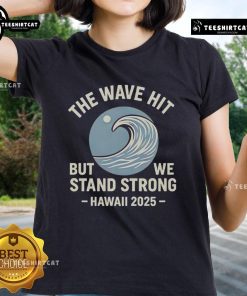 Official The Wave Hit But We Stand Strong Hawaii 2025 Ladies Tee featuring a vibrant design for beach lovers.