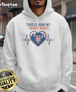 Alt Text: Official New York Mets hoodie with 'This Is How My Heart Beats' design, perfect for fans and cozy wear.