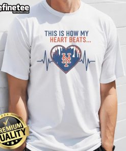 Alt Text: Official This Is How My Heart Beats New York Mets T-Shirt featuring team colors and logo, perfect for fans.