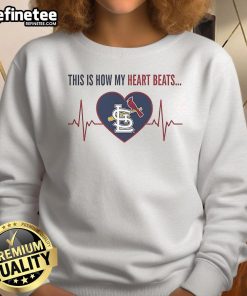 Official St. Louis Cardinals sweatshirt with 'This Is How My Heart Beats' design, perfect for fans and cozy wear.