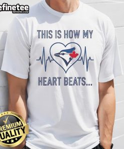 Alt Text: Official This Is How My Heart Beats Toronto Blue Jays T-Shirt featuring vibrant team colors and logo, perfect for fans.