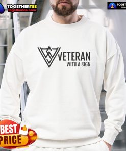 Official veteran wearing a logo sweatshirt, proudly displaying a sign supporting veteran causes.