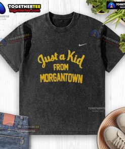 Alt Text: Official West Virginia Mountaineers 'Just A Kid From Morgantown' washed t-shirt displayed on a wooden background.