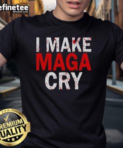 Alt Text: Official Make Maga Cry T-Shirt featuring bold text design in red and white on a black fabric background.