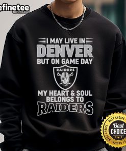 Alt Text: Cozy sweatshirt featuring 'I May Live In Denver, But On Gameday My Heart Belongs To Las Vegas Raiders' design.