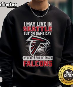 Alt Text: Cozy sweatshirt featuring I May Live In Seattle But My Heart Belongs To Atlanta Falcons design for fans.