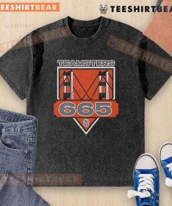 Alt Text: Original Teamsters Local 665 washed t-shirt displayed on a wooden background, showcasing its vintage design and logo.