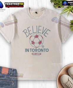 Original Toronto FC Homage MLS x Ted Lasso Believe washed t-shirt in vibrant red, showcasing team spirit and style.
