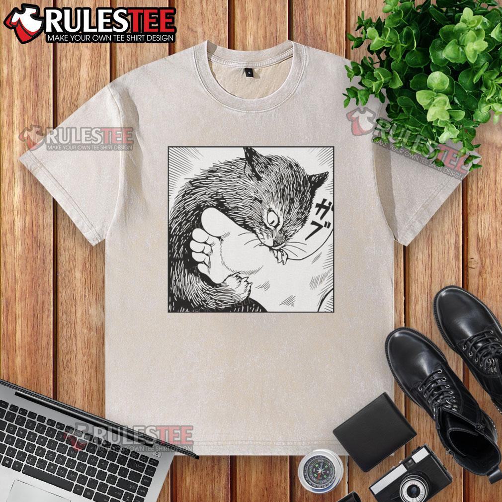 Premium Cat Bites Feet Cartoon Washed T Shirt Alt Text: Cartoon design of a cat playfully biting feet on a premium washed t-shirt, perfect for cat lovers and casual wear.