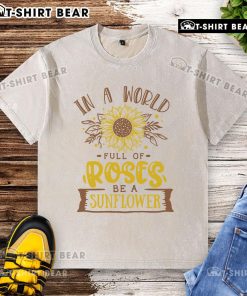 Premium 'Be a Sunflower' washed t-shirt design amidst vibrant roses, perfect for casual summer style.