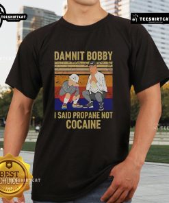 Alt Text: Premium King Of The Hill Hank T-Shirt featuring Damnit Bobby, I said propane not cocaine design. Perfect for fans!