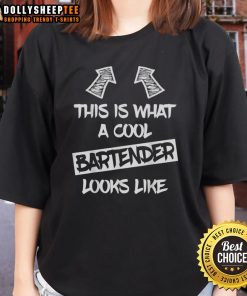 Stylish woman in a cool bartender tee, showcasing confidence and flair in a trendy bar setting.