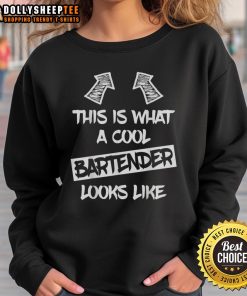 Cool bartender wearing a Premium sweatshirt, showcasing stylish design and a confident vibe in a lively bar setting.