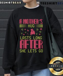 Cozy sweatshirt featuring the phrase 'A Mother's Hug Lasts Long After She Lets Go' for loving moms.