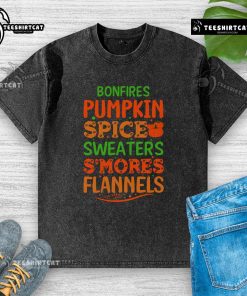 Cozy scene with pretty bonfires, pumpkin spice, sweaters, s'mores, and flannels on a washed t-shirt background.