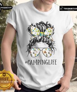 Mom wearing a 'Pretty Camping Life' t-shirt with a messy bun, enjoying the outdoors while camping.