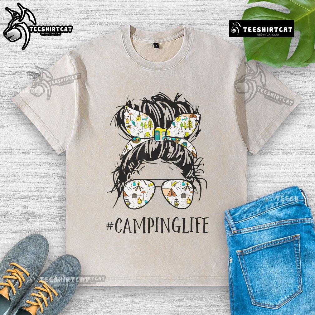 Pretty Camping Life Mom Messy Bun Mom Camping Life Washed T Shirt Mom enjoying a pretty camping life in a messy bun, wearing a washed T-shirt, surrounded by nature and camping gear.