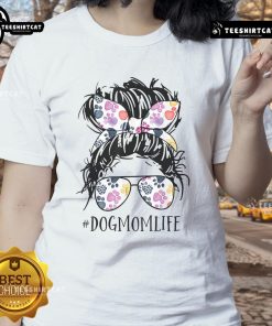 Pretty dog mom in a messy bun wearing a tee, celebrating Mother's Day with her furry friend.