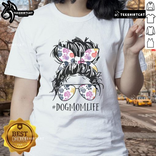 Pretty dog mom in a messy bun wearing a tee, celebrating Mother's Day with her furry friend.