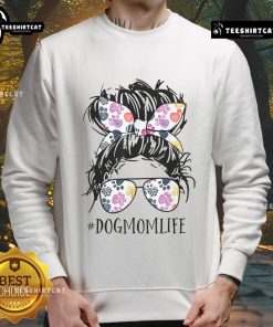 Woman with messy bun in a cozy sweatshirt celebrates Mother's Day with her dog, embodying the Pretty Dog Mom Life.