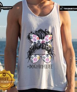 Pretty dog mom in a messy bun wearing a tank top for Mother's Day, showcasing love for her pet.