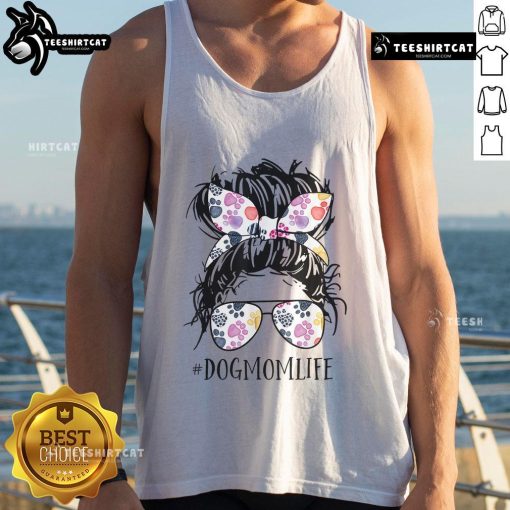 Pretty dog mom in a messy bun wearing a tank top for Mother's Day, showcasing love for her pet.