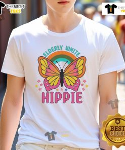 Alt Text: Pretty elderly white hippie wearing a retro butterfly rainbow flower t-shirt, embracing a vibrant bohemian style.