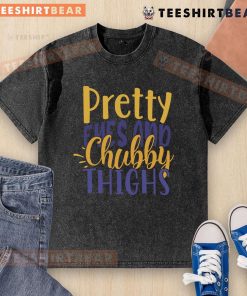 Pretty Eyes and Chubby Thighs washed t-shirt displayed on a hanger, showcasing its soft fabric and stylish design.