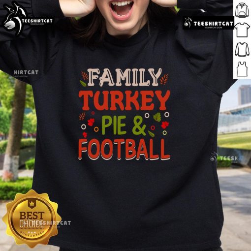 Pretty family wearing turkey pie and football sweatshirts, celebrating Thanksgiving together in a cozy living room.