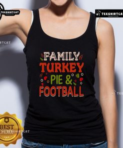 Pretty family enjoying a turkey pie dinner while wearing a football tank top, celebrating togetherness and festive traditions.