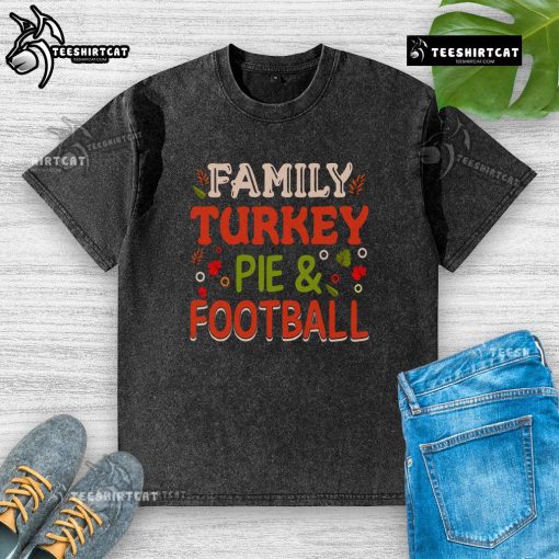 Happy family enjoying turkey pie and football, wearing washed T-shirts for a cozy holiday celebration.