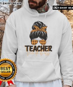 Alt Text: Pretty teacher in a messy bun wearing a cozy hoodie, showcasing the We Do It All spirit in a classroom setting.