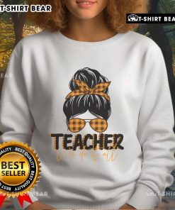 Pretty teacher in a messy bun wearing the 'We Do It All' sweatshirt, showcasing stylish and comfortable teaching apparel.