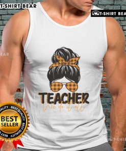 Pretty teacher in a messy bun wearing a tank top, exuding confidence and style in a vibrant classroom setting.