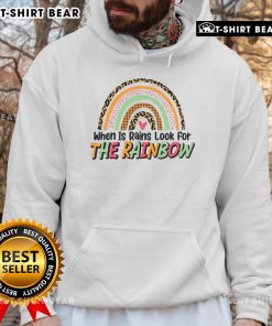 Colorful 'Pretty When It Rains Look For The Rainbow' hoodie displayed against a vibrant rainbow backdrop, perfect for rainy days.