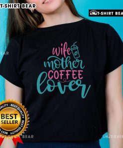 Pretty wife and mother enjoying coffee while wearing a stylish 'Coffee Lover' ladies tee, radiating warmth and happiness.