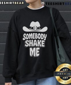Top baseball cowboy hat and 'Somebody Shake Me' sweatshirt on a stylish display, perfect for casual outfits.