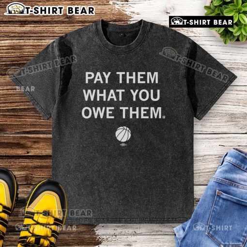Top Basketball Pay Them What You Owe Them washed t-shirt displayed on a hanger, featuring a stylish design for fans.
