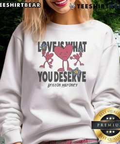 Alt Text: Cozy 'Love Is What You Deserve' sweatshirt by Briston Maroney featuring sad and happy hearts design.