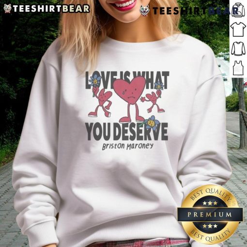 Alt Text: Cozy 'Love Is What You Deserve' sweatshirt by Briston Maroney featuring sad and happy hearts design.